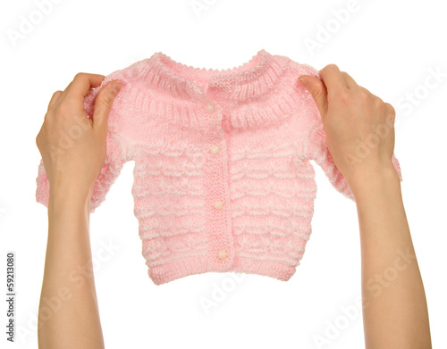Billede på lærred Knitted jacket in the female hands