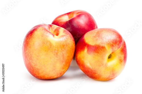 Close up of three peaches, isolated