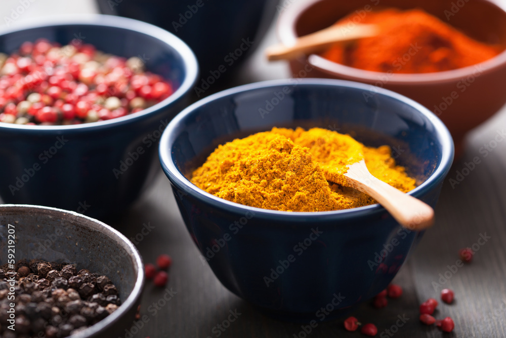 spices in bowls: curry, pink and black pepper, paprika powder spices in bowls: curry, pink and black pepper, paprika powder