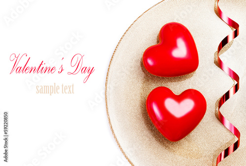 Two Big Red hearts on a golden plate isolated on white with fest