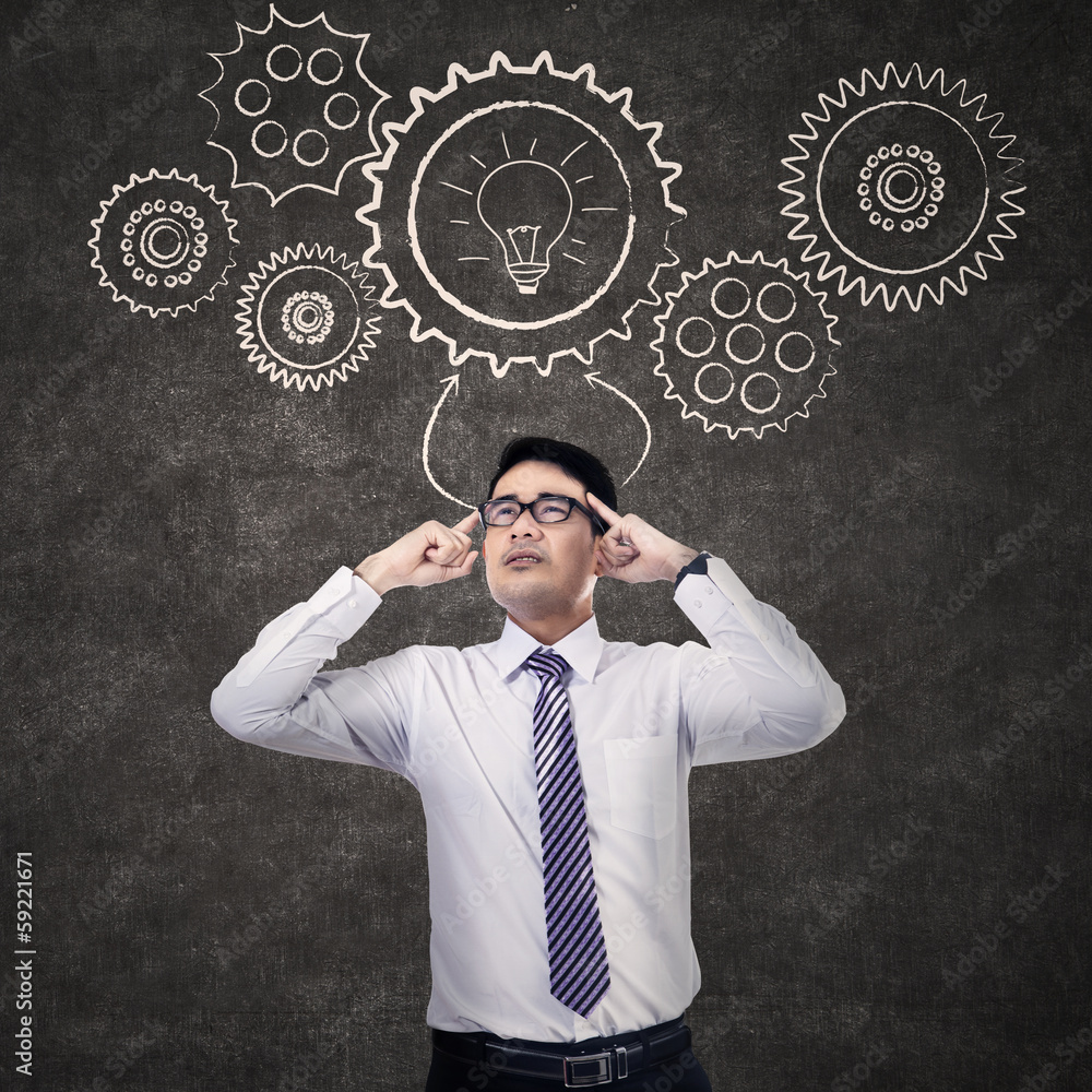 Thinking businessman with mechanisms Thinking businessman with mechanisms