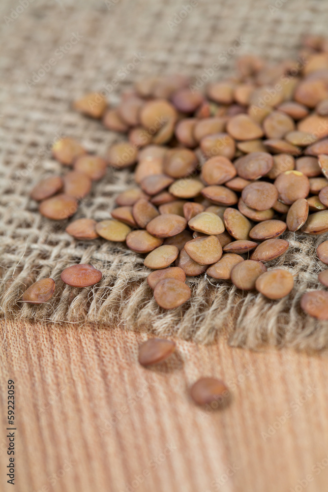 brown lentils on wooden table brown lentils on wooden table
