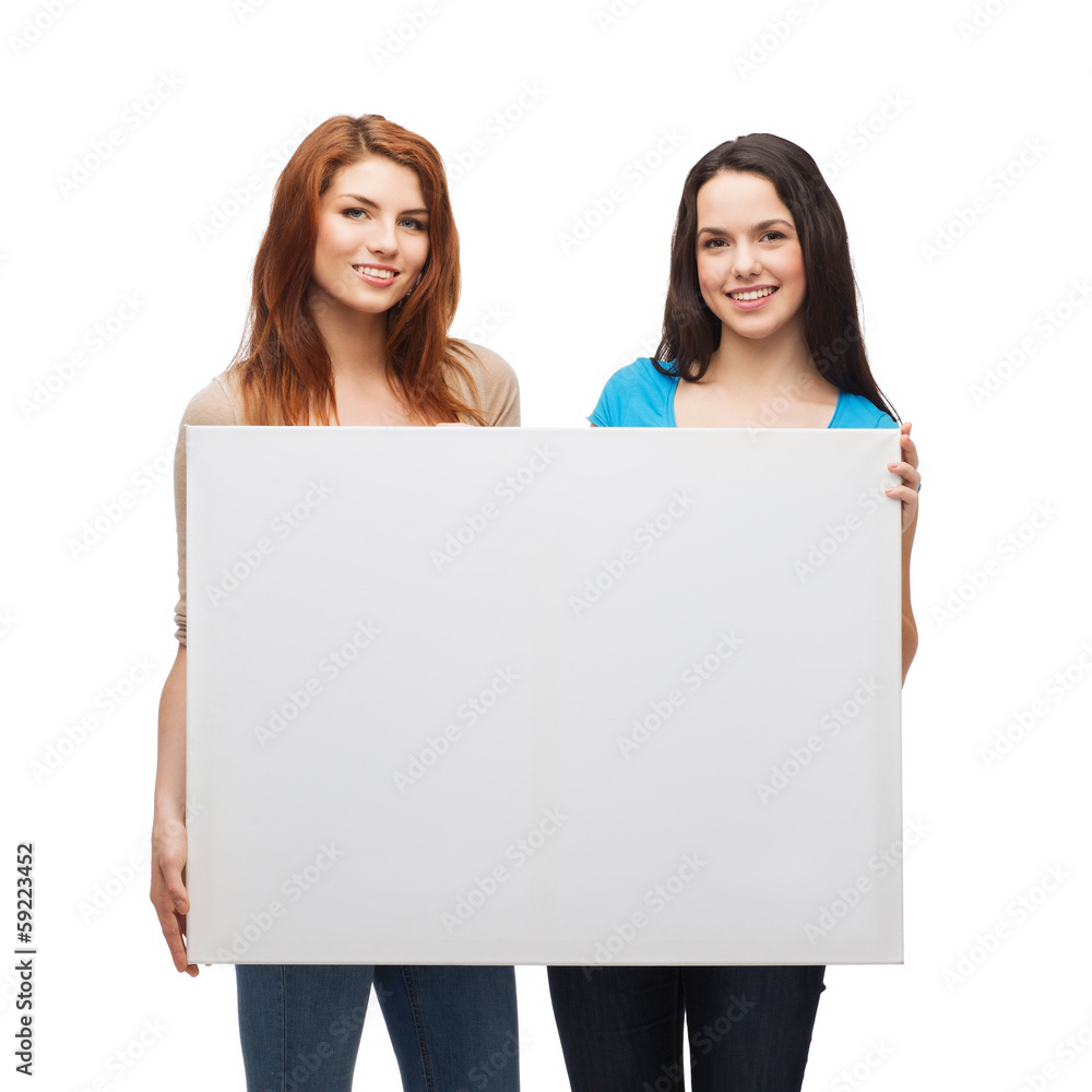 two smiling young girls with blank white board two smiling young girls with blank white board