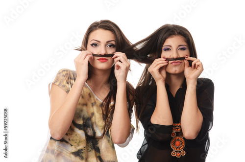 Girls having fun and making mustaches out of each others hair