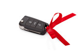 Gift idea: car keys with red ribbon isolated on white background