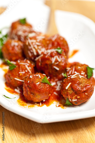 Meatballs in tomato sauce with parsley and parmesan