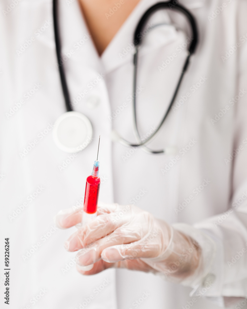 syringe in doctor's hand syringe in doctor's hand