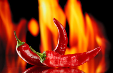 Red hot chili peppers on fire background