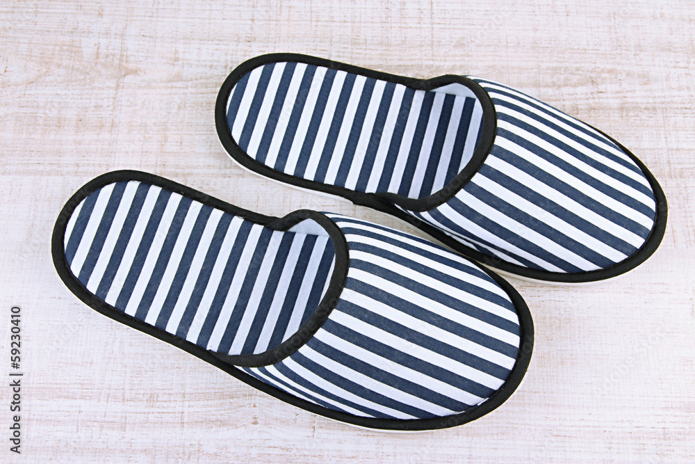 Striped slippers on wooden background Striped slippers on wooden background