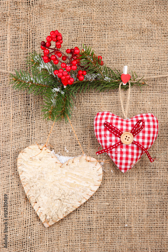 Decorative hearts on rope, on burlap background Decorative hearts on rope, on burlap background