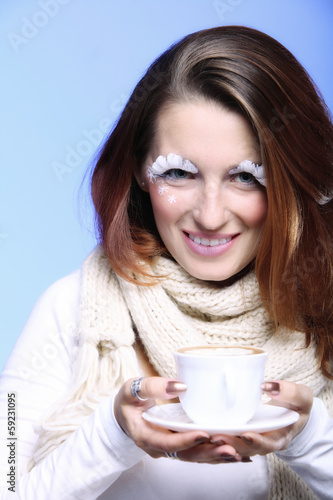 Winter makeup woman with cup of hot latte coffee