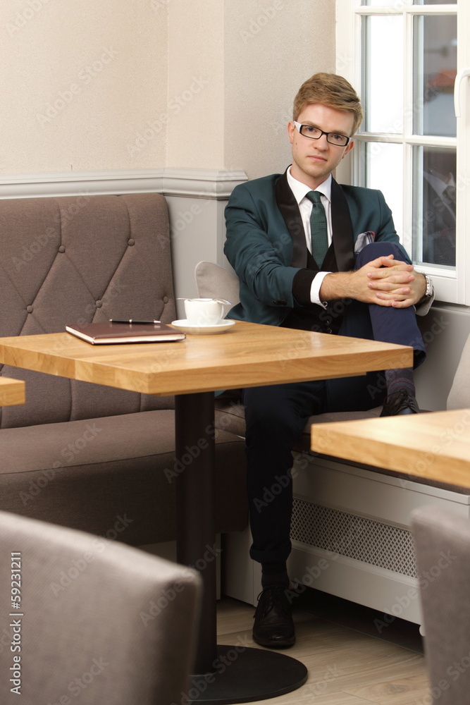 Young handsome stylish man in cafe with coffee Young handsome stylish man in cafe with coffee