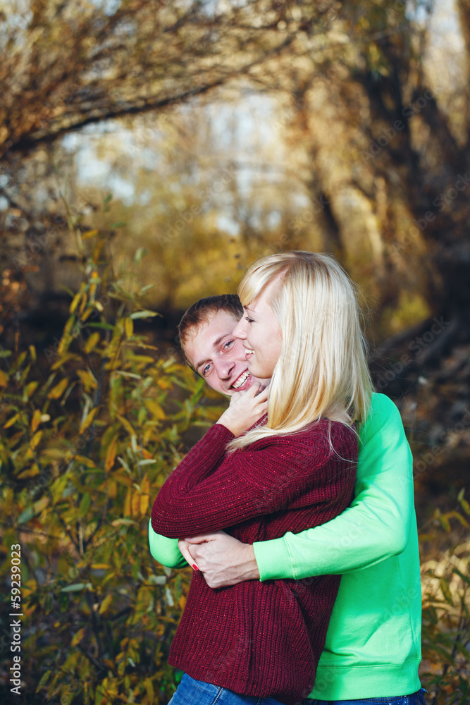 Young couple on banks of river Young couple on banks of river