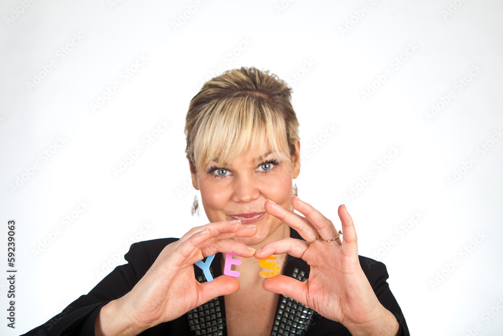Studio portrait of a cute blond girl holding two letters forming Studio portrait of a cute blond girl holding two letters forming