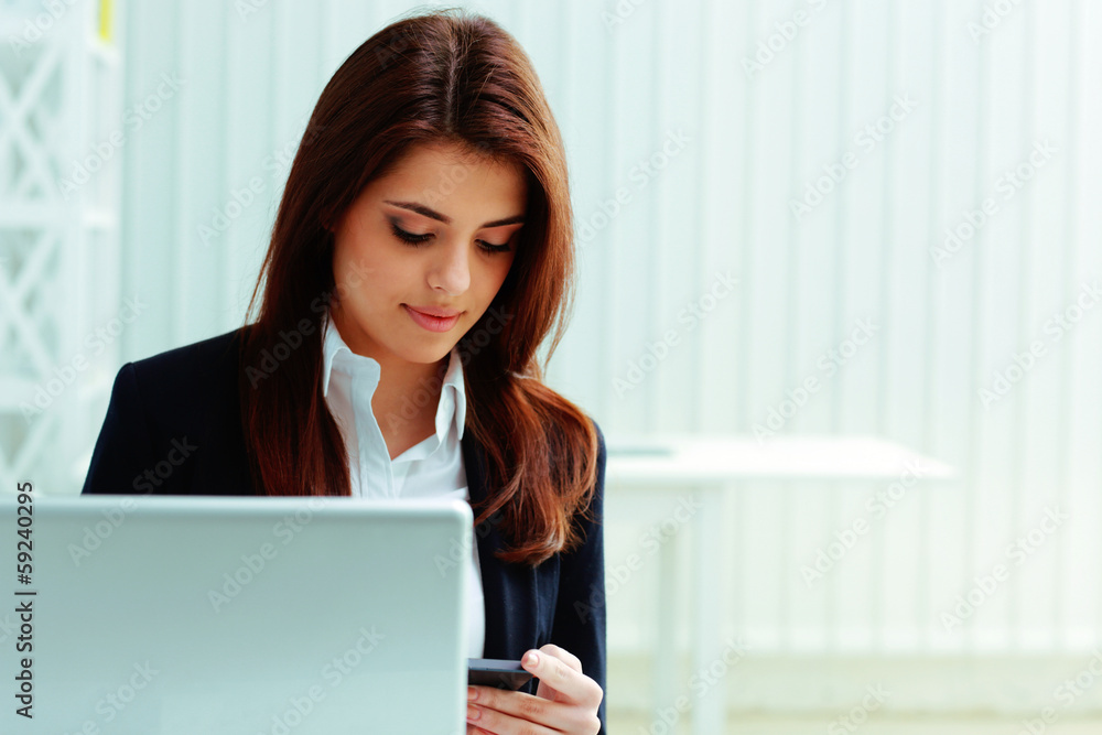 Young businesswoman looking at smartphone Young businesswoman looking at smartphone