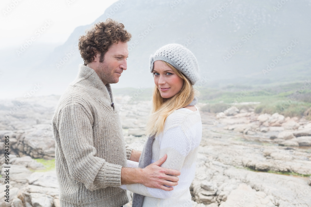 Couple standing together on a rocky landscape Couple standing together on a rocky landscape