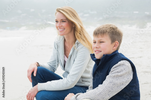 Casual woman and son relaxing at beach © lightwavemedia