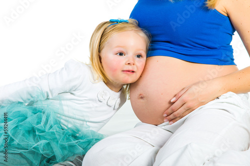 Pregnant woman with 2 zo daughter on white