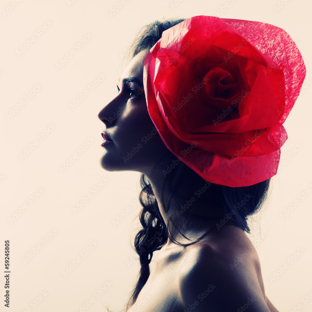 Fototapeta premium Vintage portrait of fashion glamour girl with red flower in her