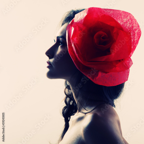 Vintage portrait of fashion glamour girl with red flower in her photo