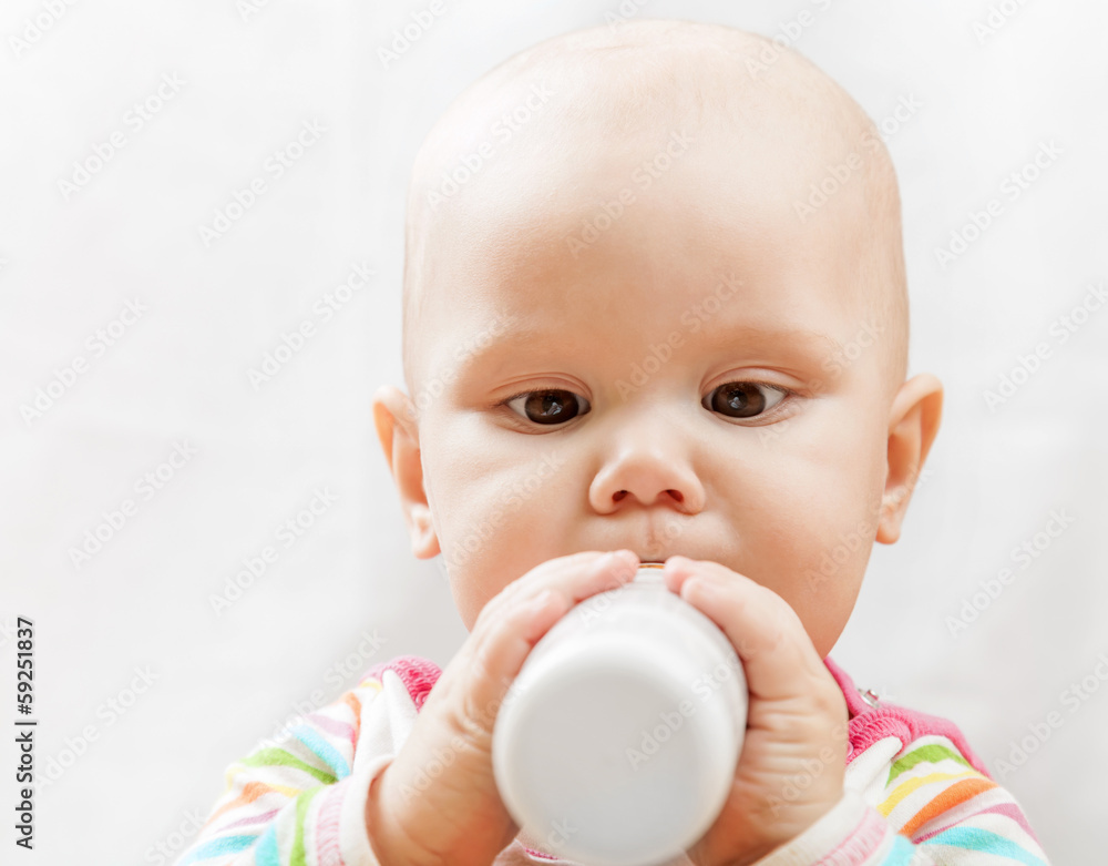 Little Caucasian baby with bottle of milk Little Caucasian baby with bottle of milk