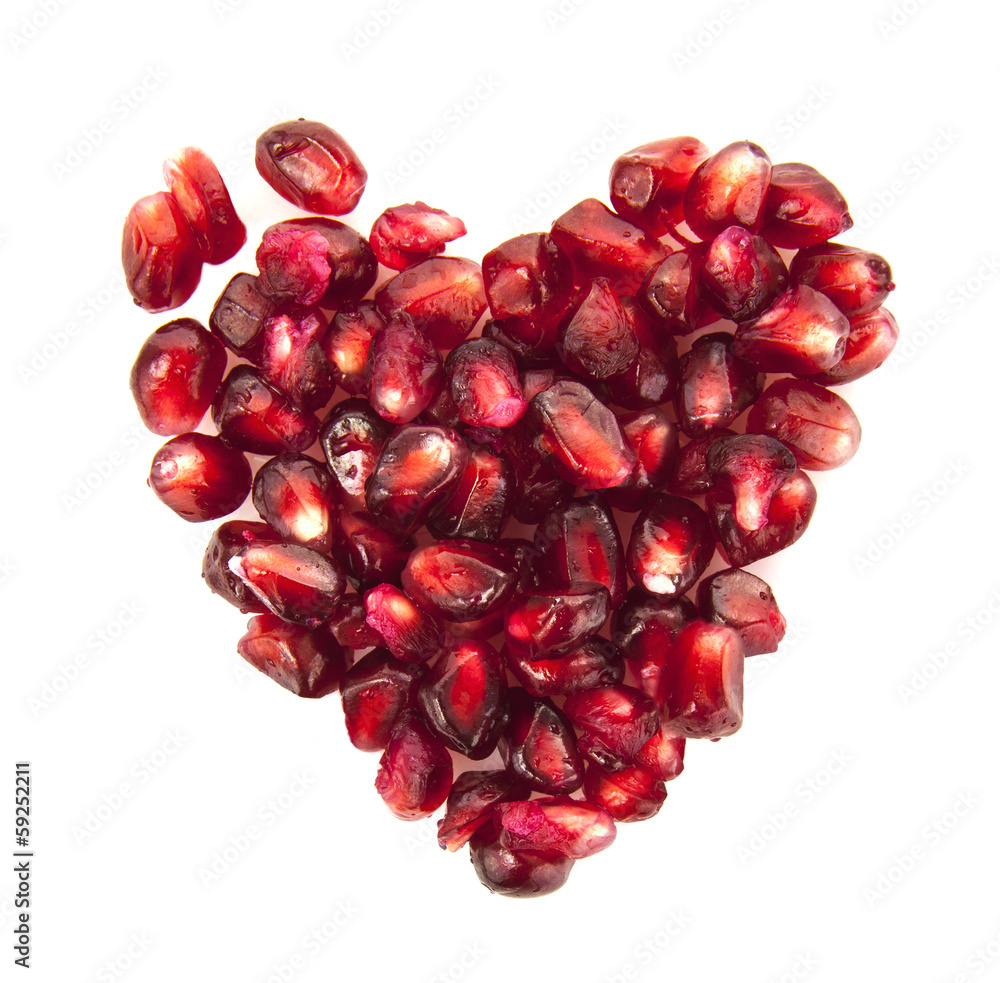 Heart of pomegranate seeds on white background Heart of pomegranate seeds on white background