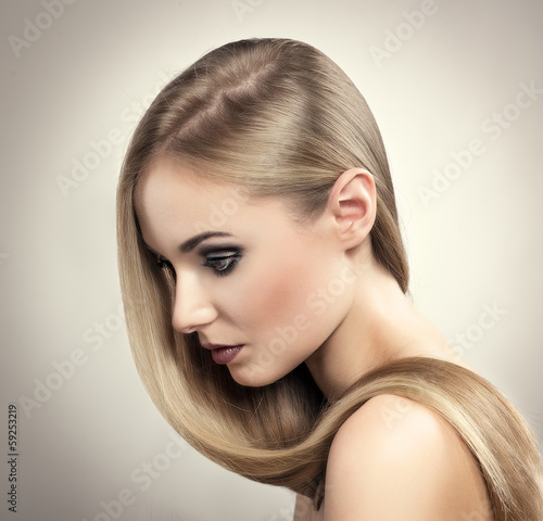 Beautiful blonde salon model with professional make-up