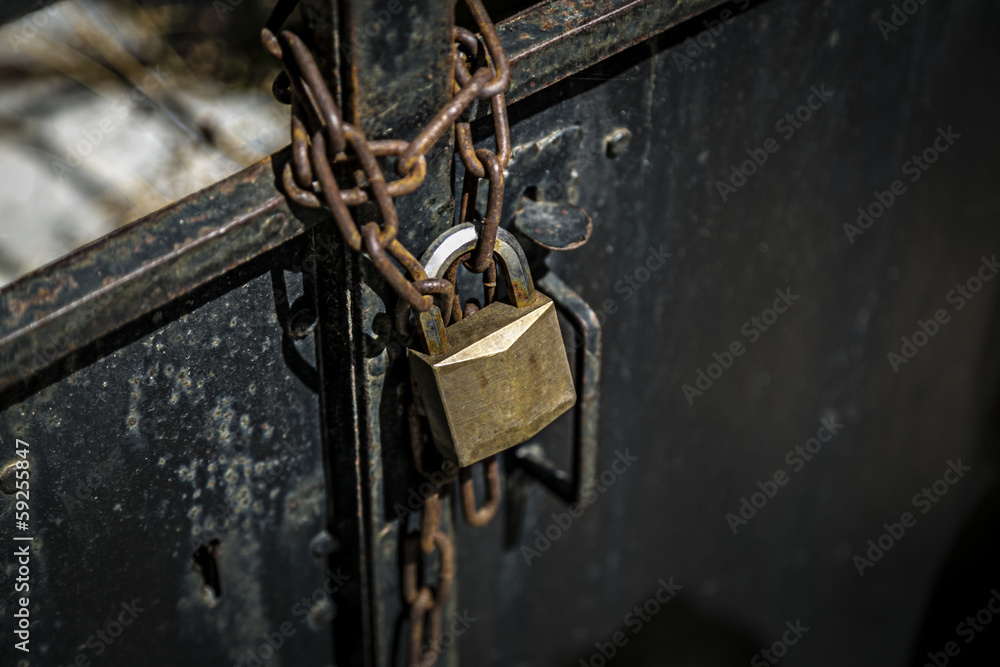 rusty chain on a metal door with padlock rusty chain on a metal door with padlock