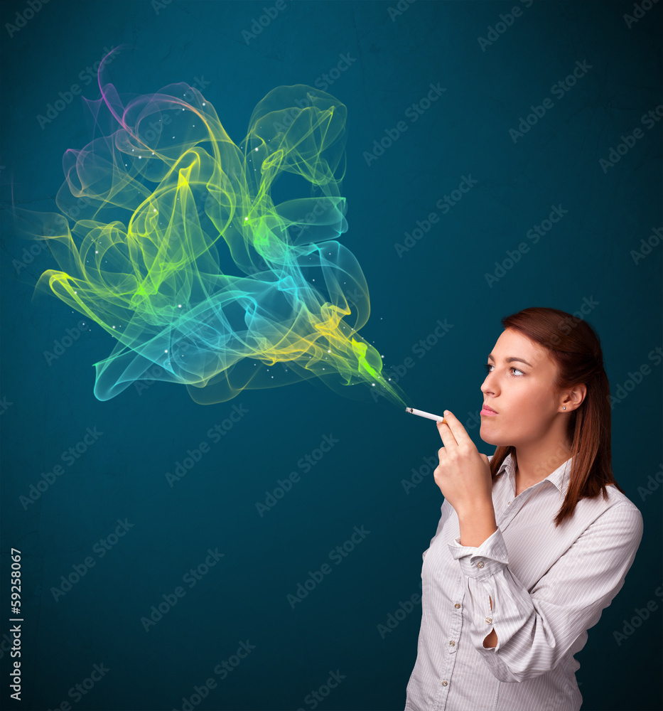Fototapeta premium Pretty lady smoking cigarette with colorful smoke