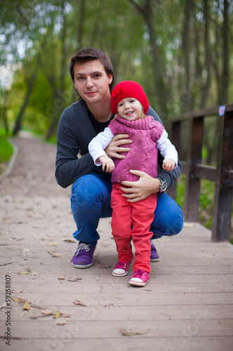 Portrait of happy father with daughter in the park at warm