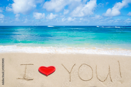 Sign "I love you" on the sandy beach