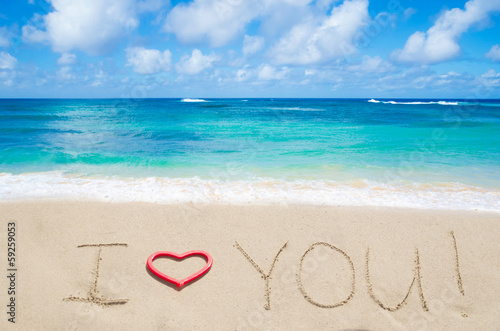 Sign "I love you" on the sandy beach
