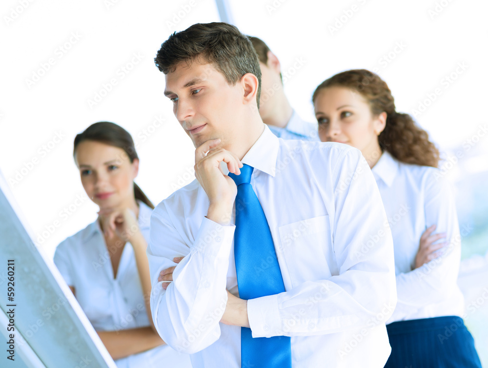 businessmen are meeting near the flipchart businessmen are meeting near the flipchart