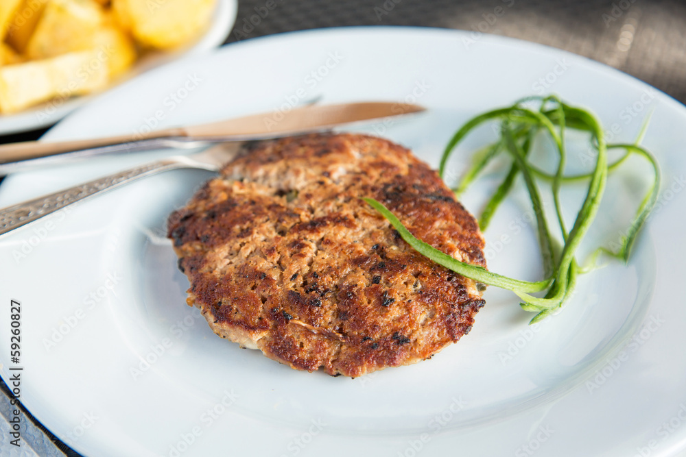 Grilled meat cutlet served