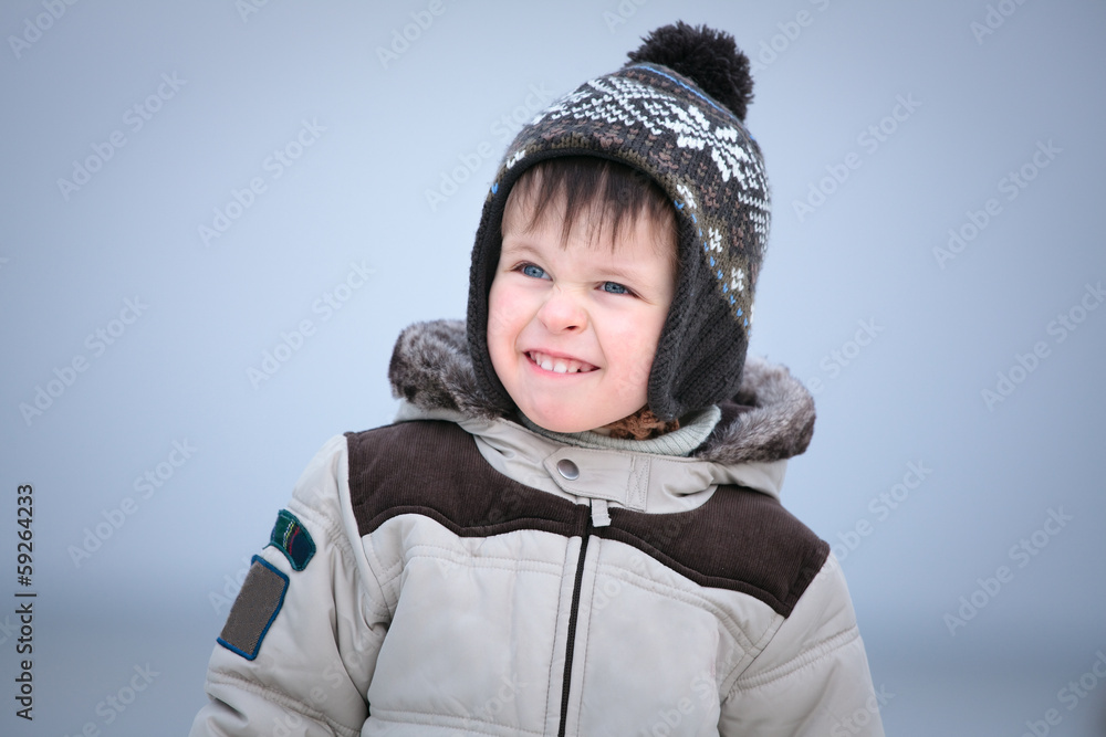 Attractive little boy having fun on winter beach Attractive little boy having fun on winter beach
