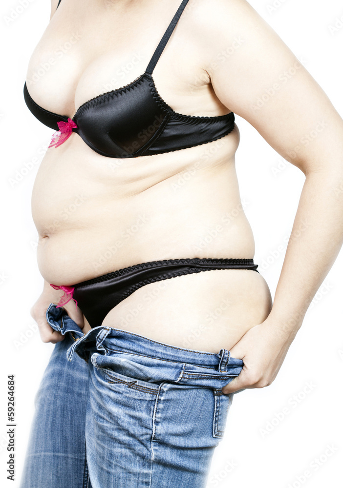 Fat woman trying to put on her tight jeans Stock Photo | Adobe Stock