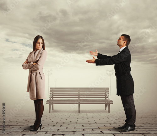 young man apologizing to woman photo