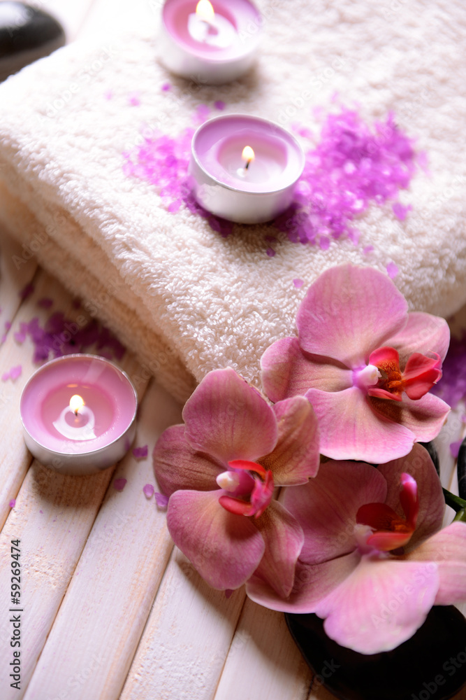 Still life with beautiful blooming orchid flower, towel and spa Still life with beautiful blooming orchid flower, towel and spa