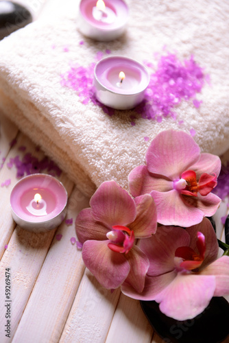 Still life with beautiful blooming orchid flower  towel and spa