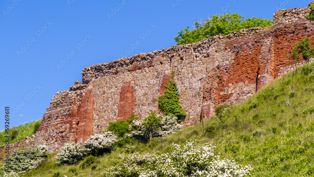 Ruin castle walls with stone and brick