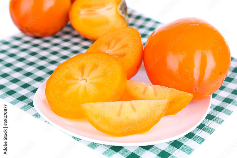 Ripe persimmons on plate close-up Ripe persimmons on plate close-up