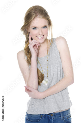 Portrait of beautiful young girl in jeans on white background