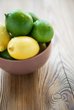 Fruits: limes and lemons, vertical shot