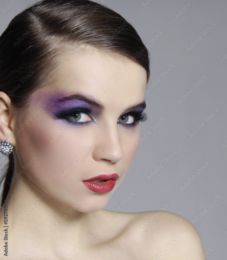 Beautiful Brunette Girl. Luxury Makeup-gray background Beautiful Brunette Girl. Luxury Makeup-gray background