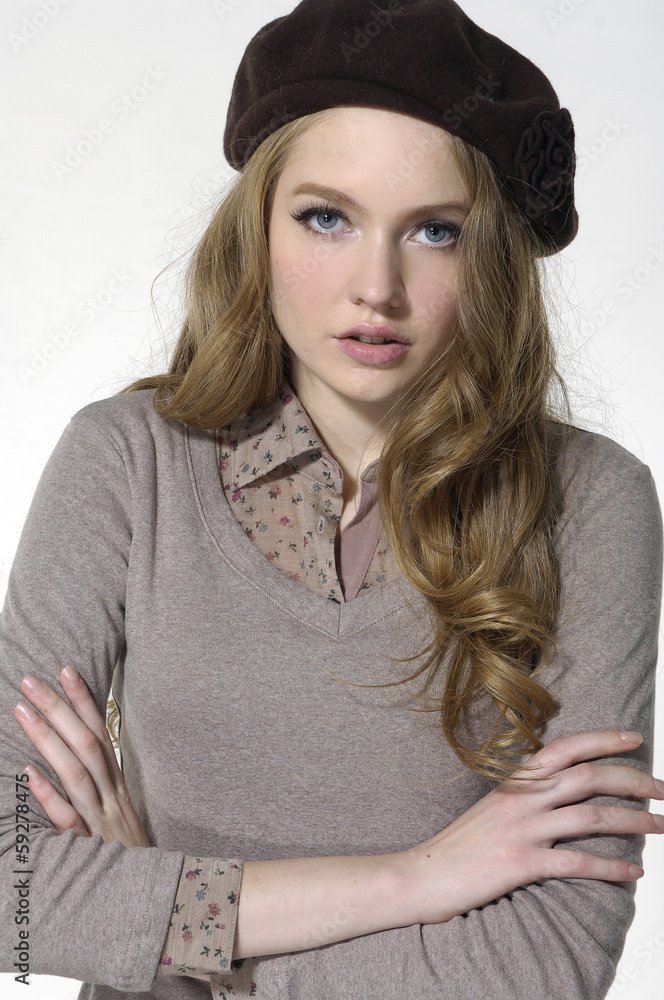 Beautiful young woman standing with arms crossed Beautiful young woman standing with arms crossed