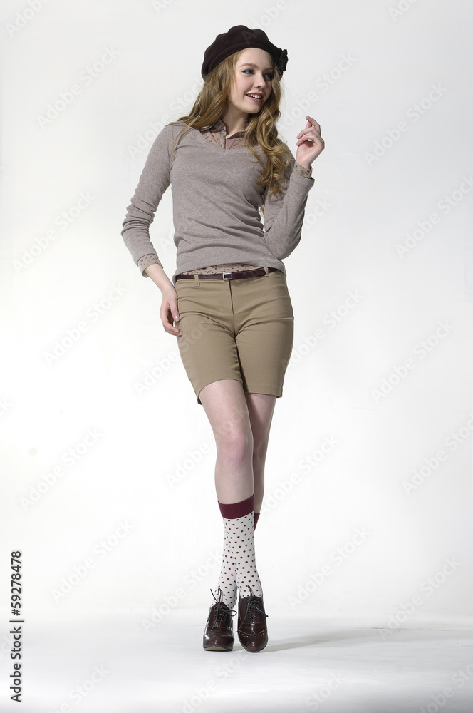 portrait of beautiful girl in cap standing in studio portrait of beautiful girl in cap standing in studio