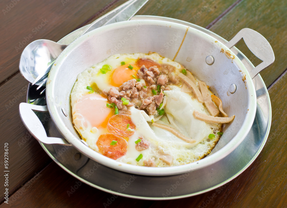 Fried egg with many topping served in pan