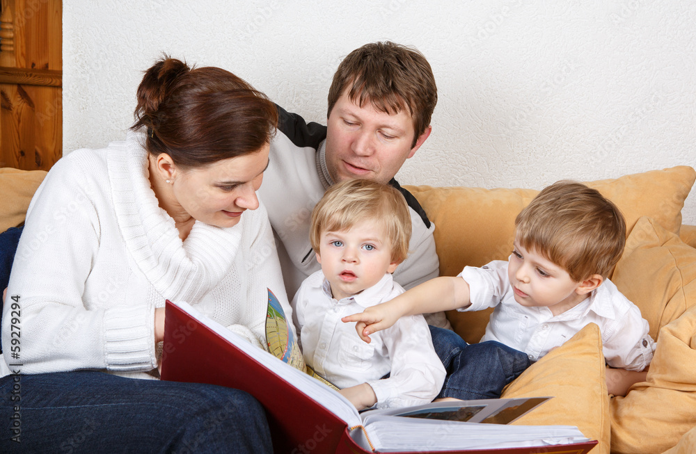 Happy family of a four planning traveling together. Happy family of a four planning traveling together.