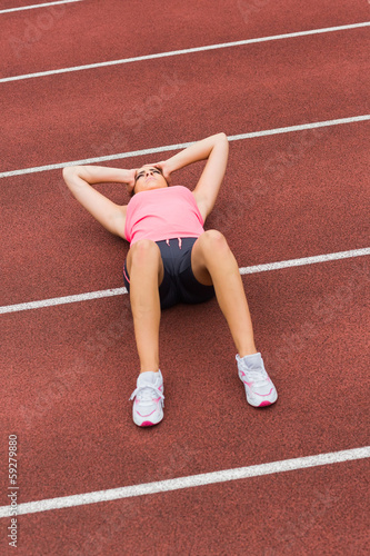 Sporty woman suffering from headache on the running track © WavebreakmediaMicro