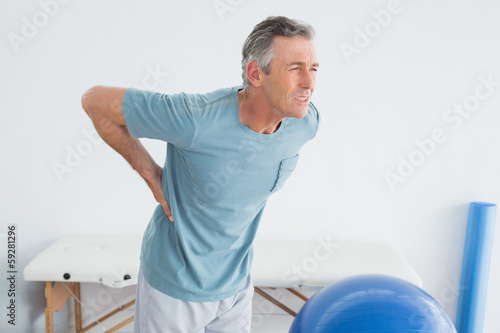 Man with lower back pain at the gym hospital